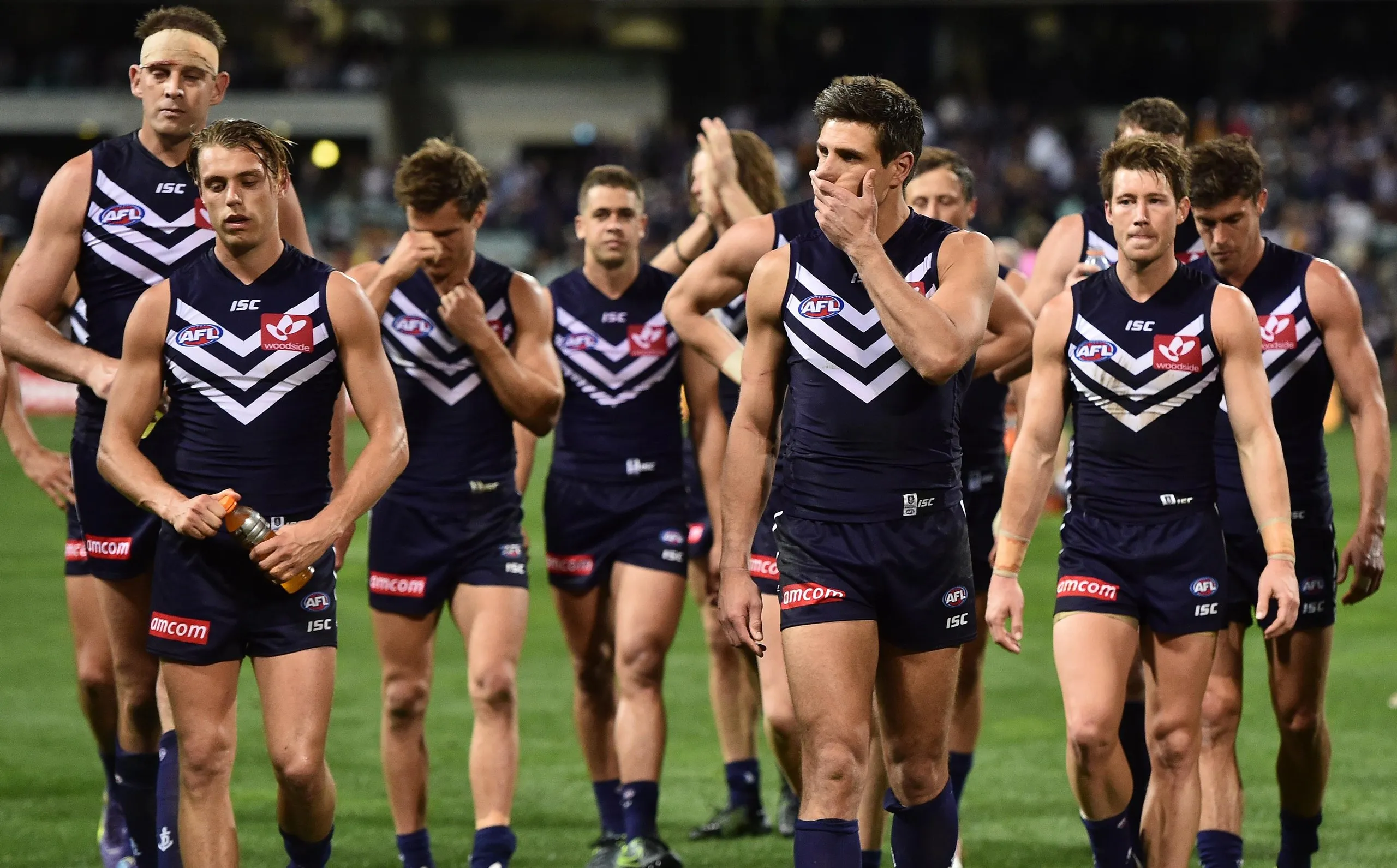 Matthew Pavlich and Dockers teammates look dejected after losing the 2015 preliminary final against the Hawks