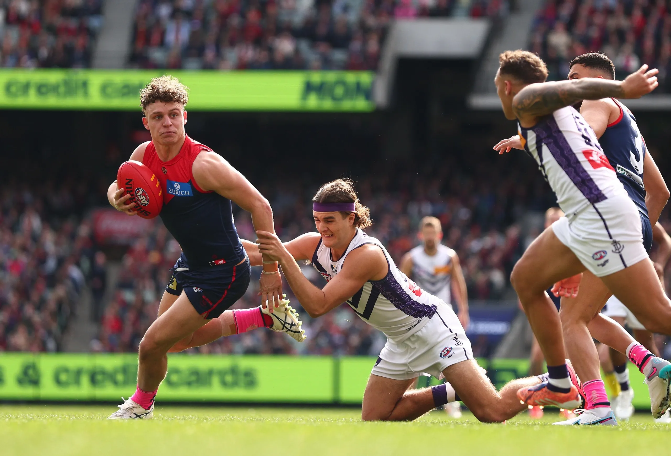 Melbourne’s Koltyn Tholstrup runs away from Fremantle’s Murphy Reid