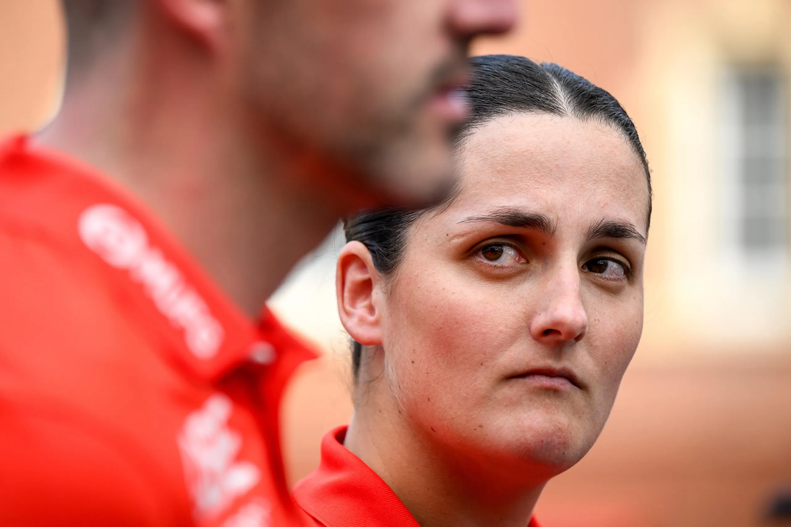 A woman looks sideways at a man’s face that is mostly out of shot 