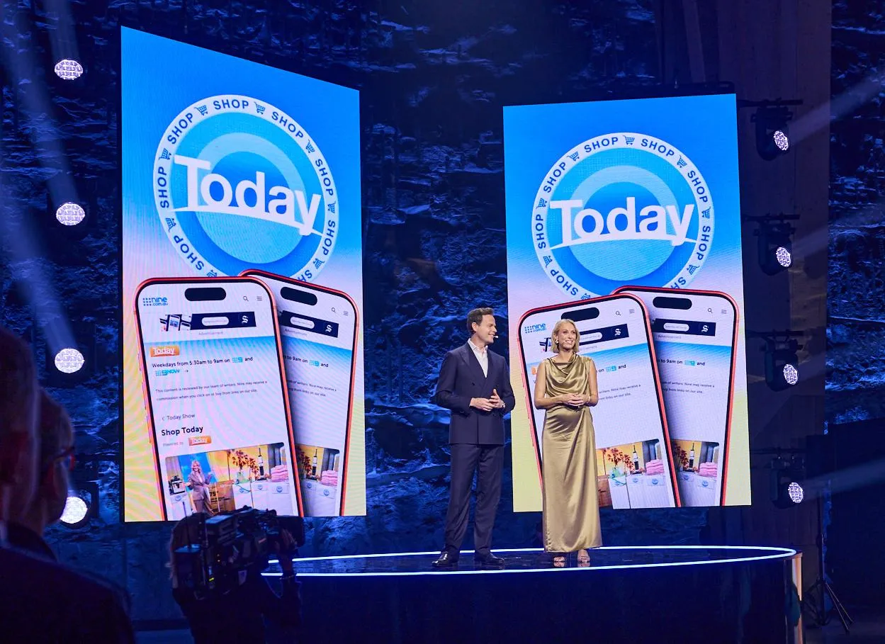 The presenters on a stage in front of screens showing the Today logo above mobile phones