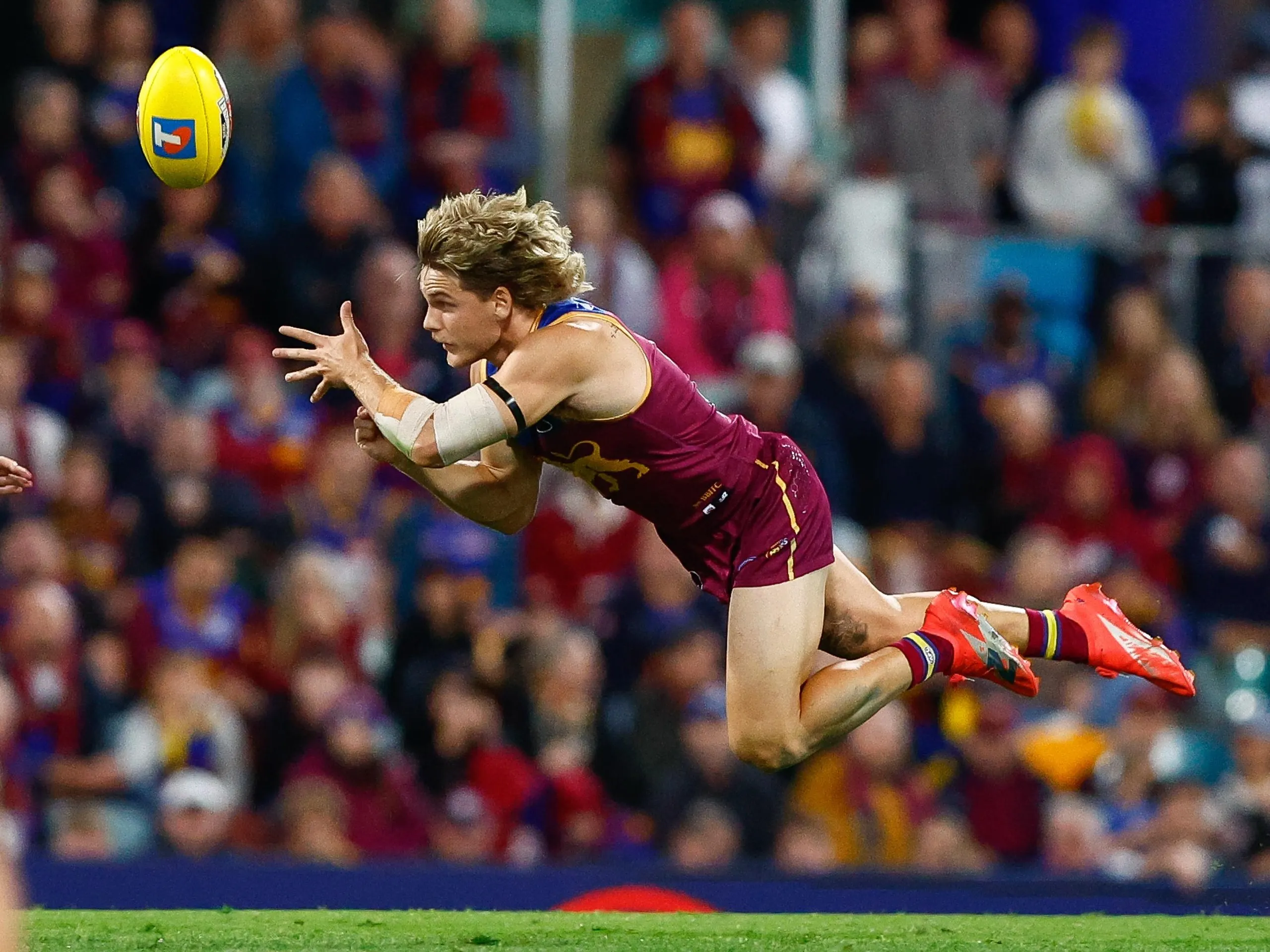 Will Ashcroft of the Lions handpasses the ball