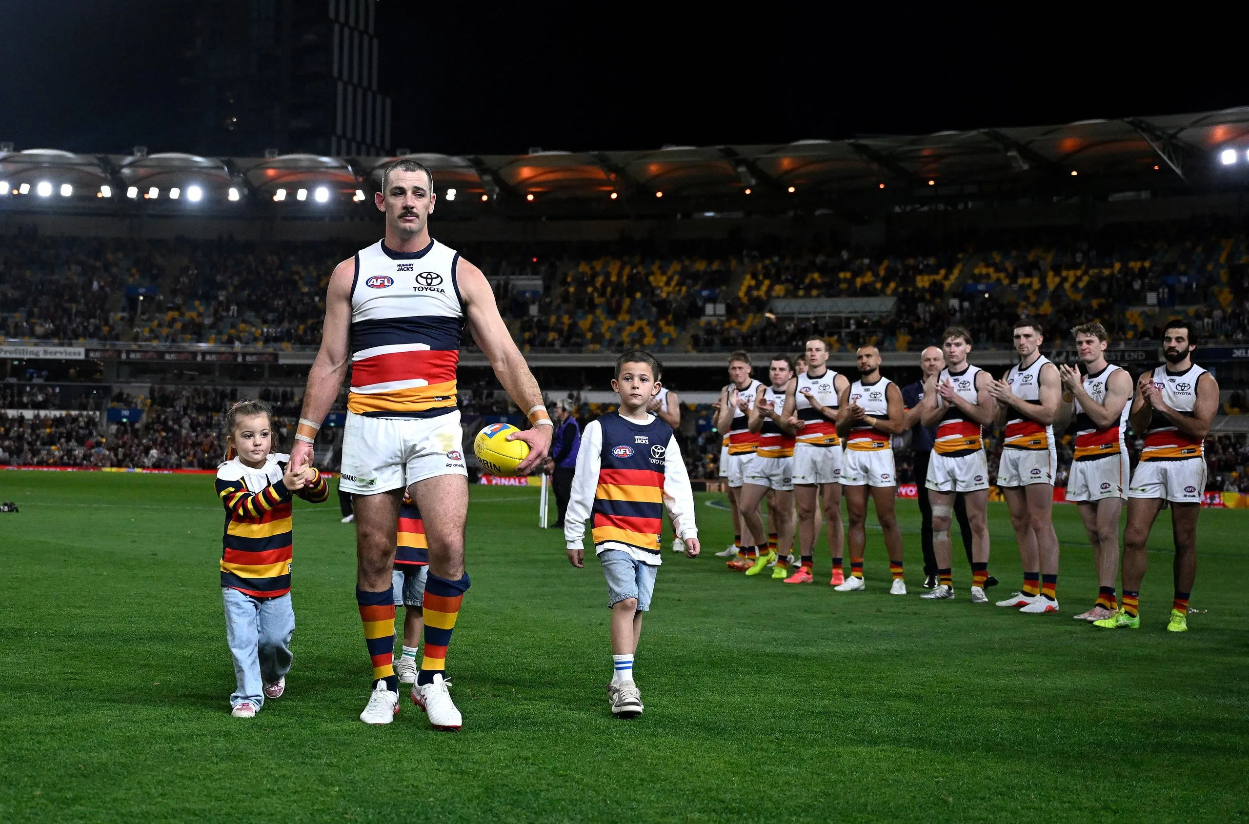 Retiring Crows great Taylor Walker leaves the field.