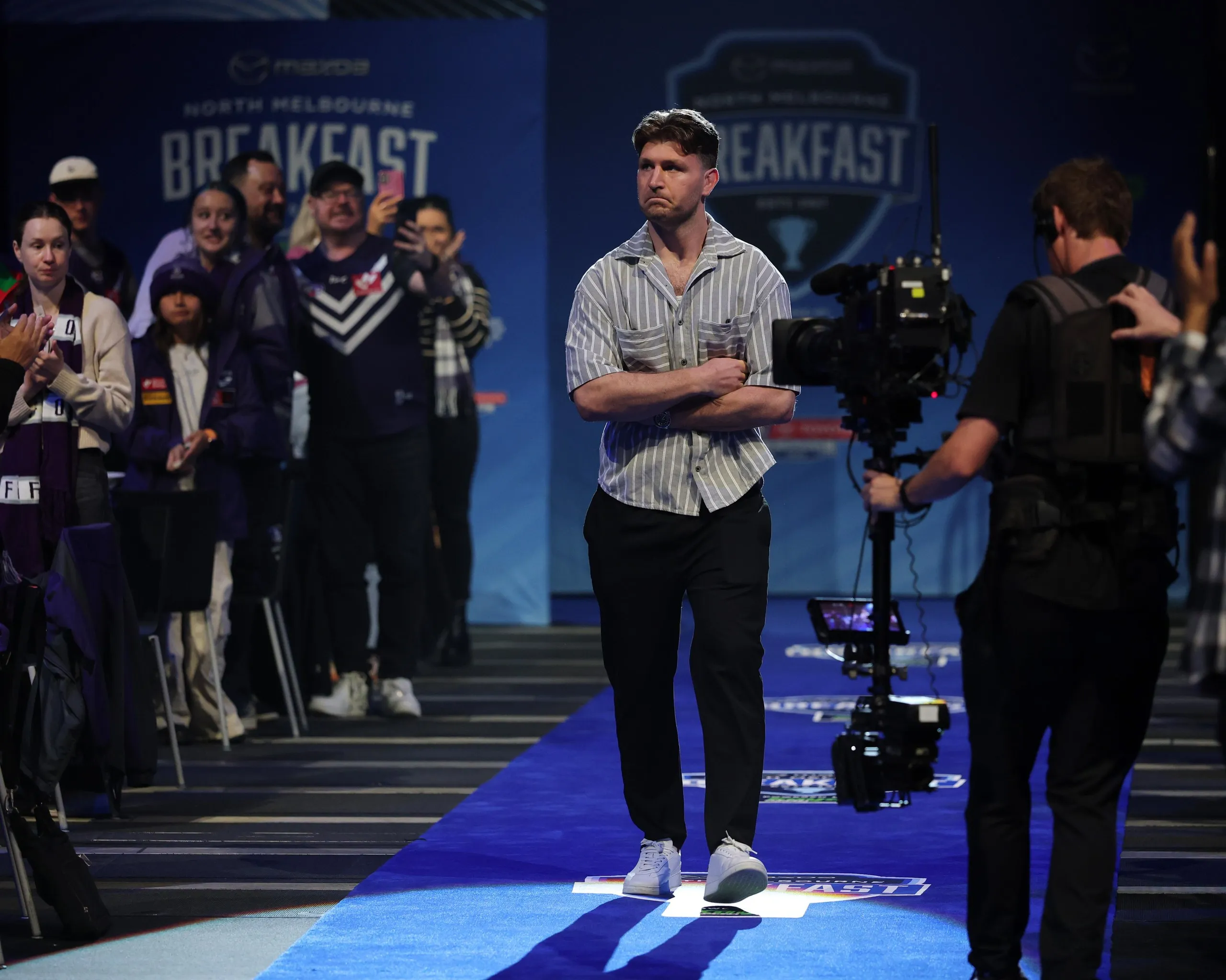 Jai Arrow receives a standing ovation as he arrives for the AFL grand final breakfast in Melbourne