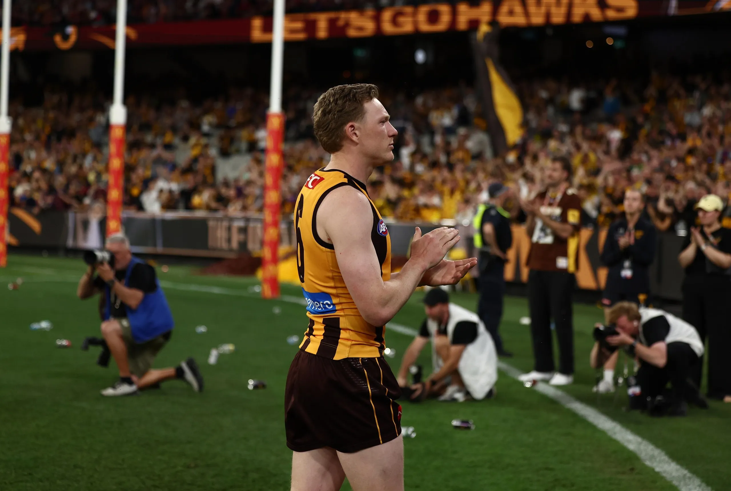 Co-captain James Sicily leads the Hawks off the field
