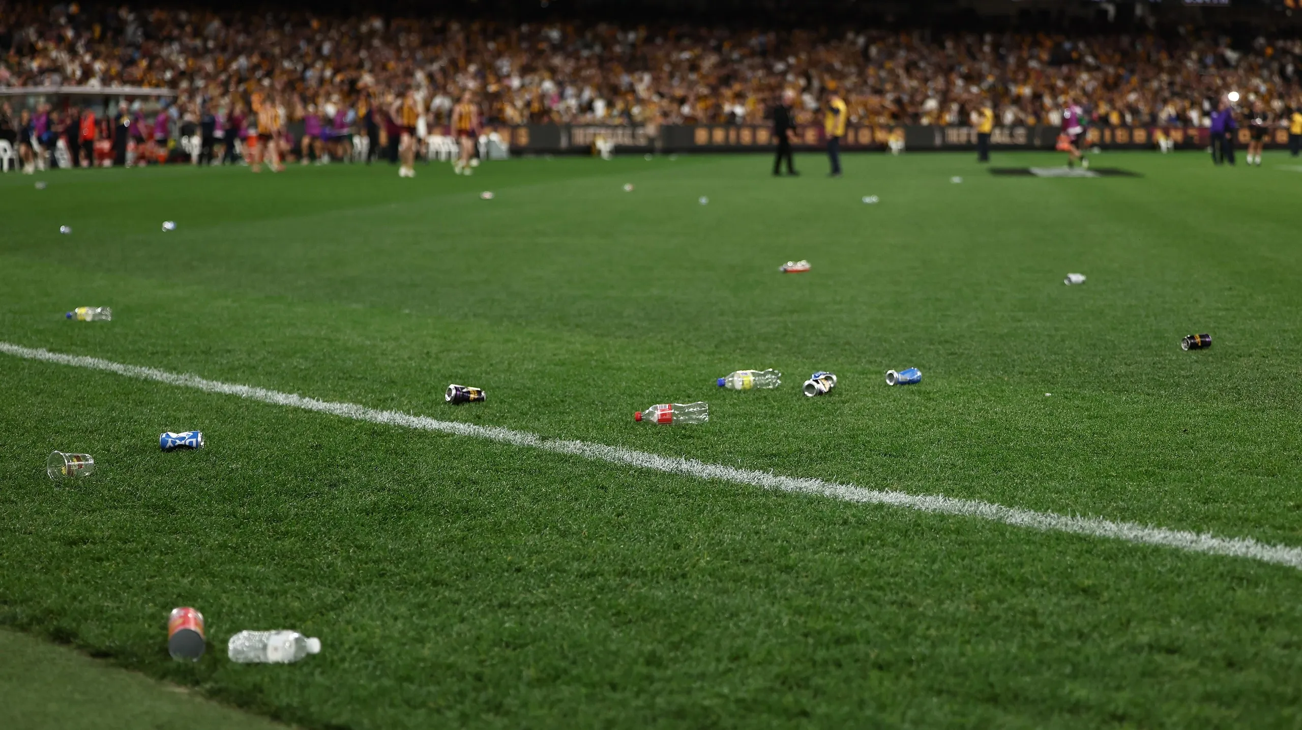 Bottles and cans on the turf at the MCG after the match