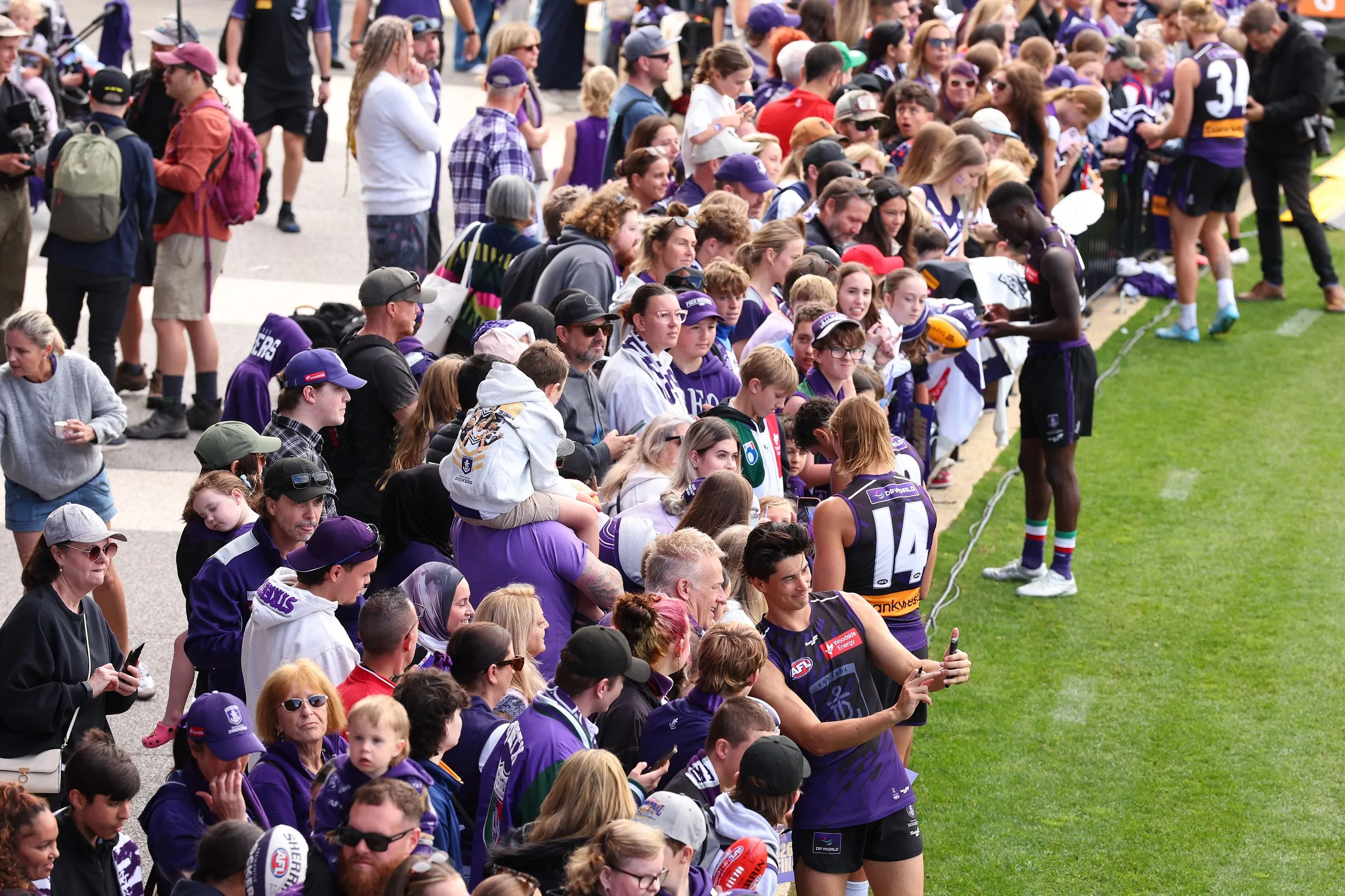 Bailey Banfield takes a selfie with Dockers fans at a training session at Cockburn ARC Oval.