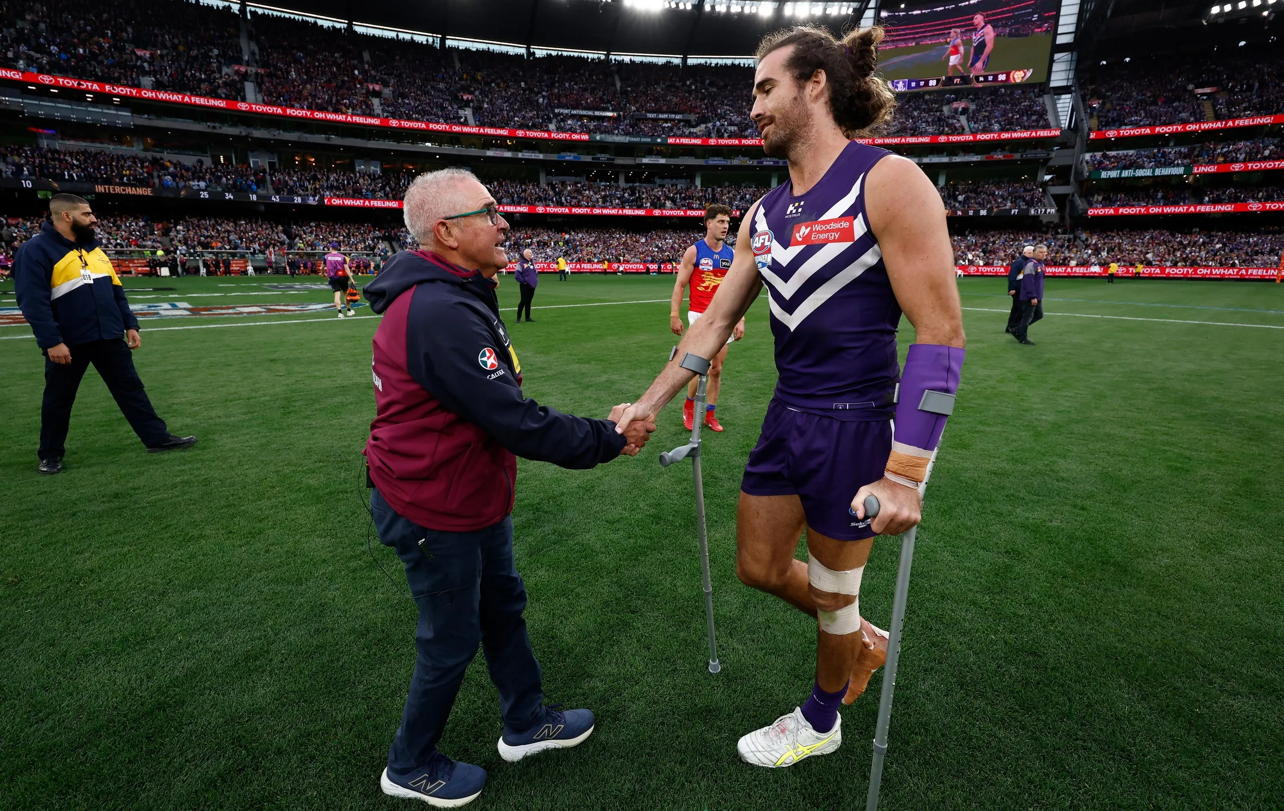 Chris Fagan shakes the hand of Alex Pearce at the end of the game at the MCG.