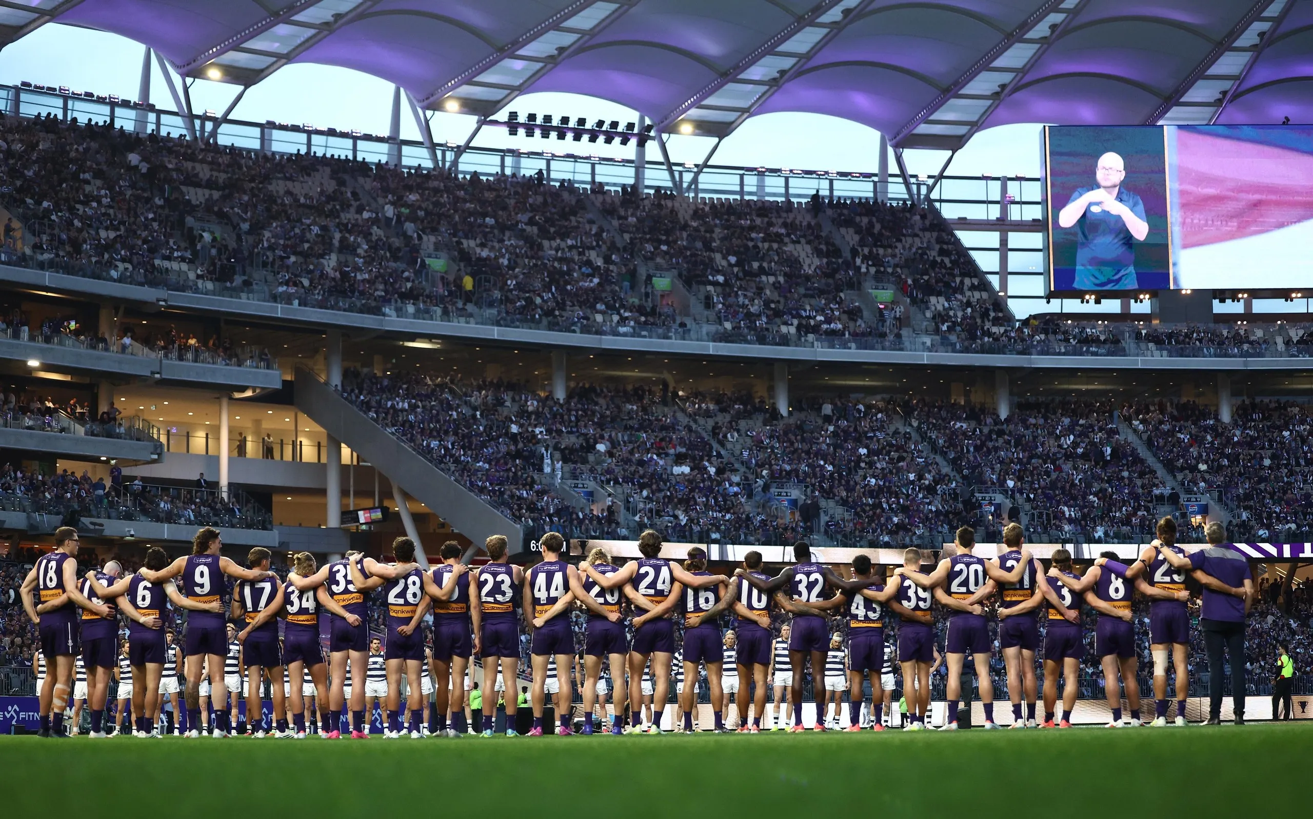Fremantle line up for the Welcome to Country and National Anthem Ceremony during the 2026 AFL First Semi Final against Geelong.