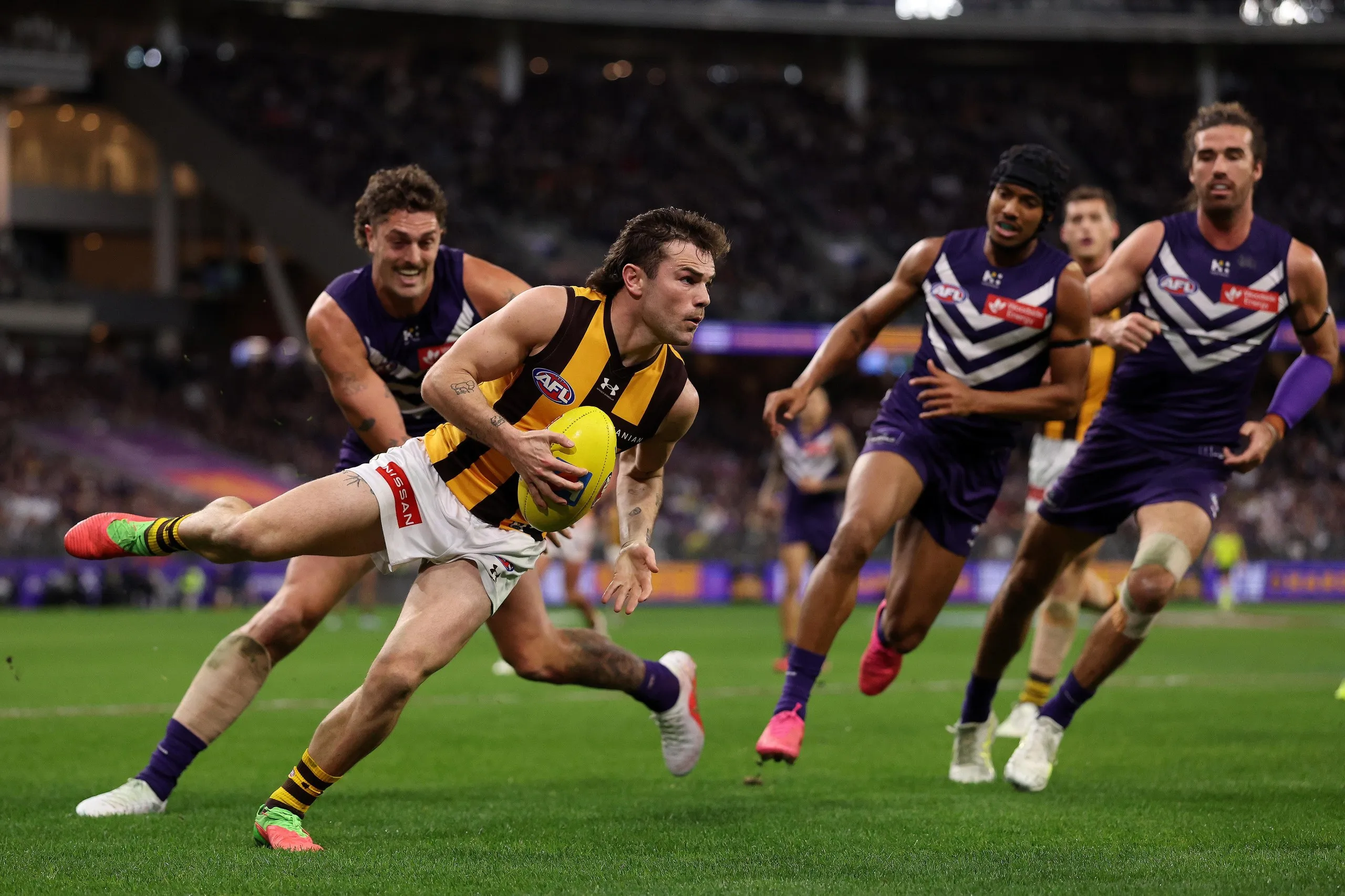 Nick Watson runs with the ball during the qualifying final as Fremantle players give chase